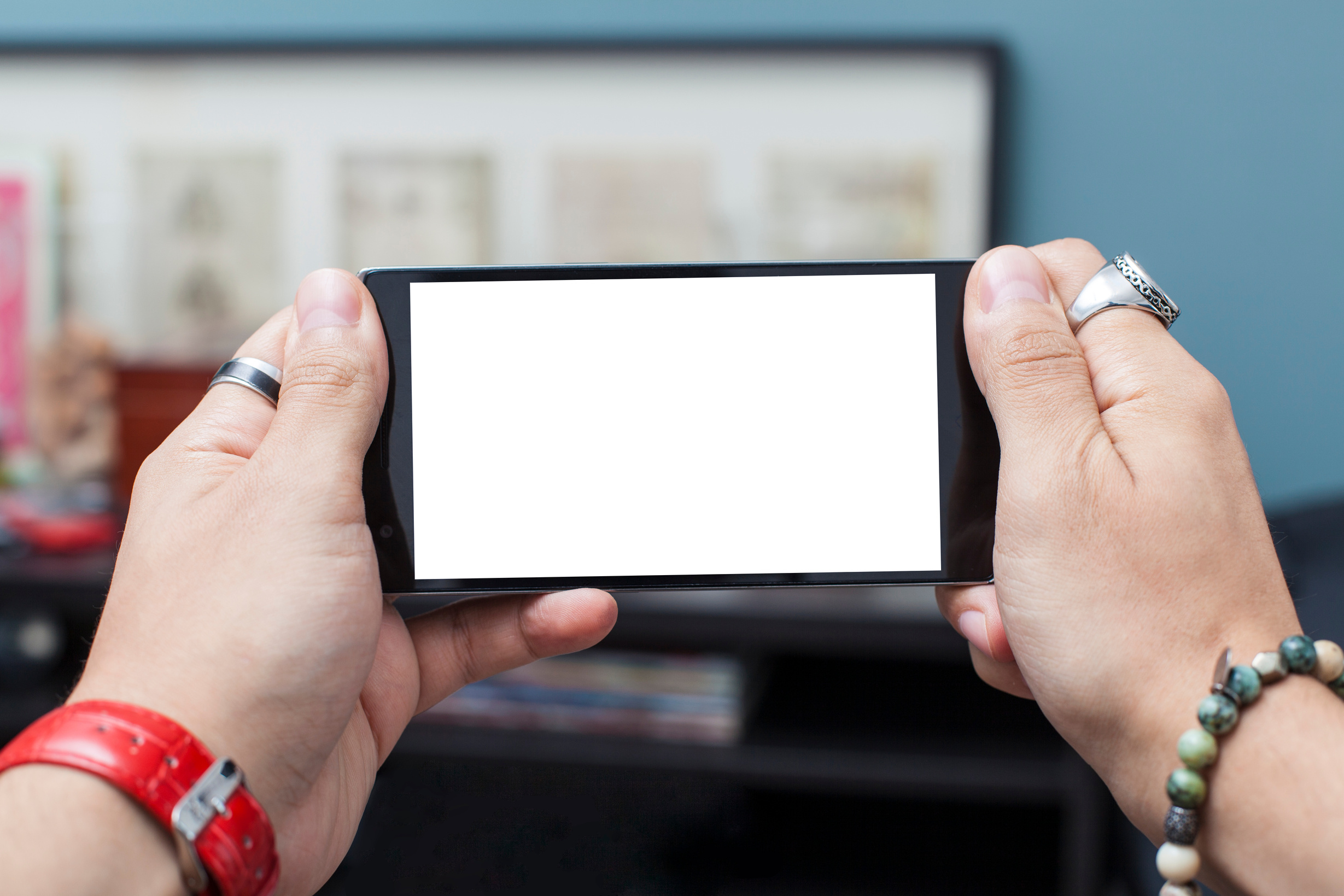 Man Holding a Smartphone with Both Hands on Landscape