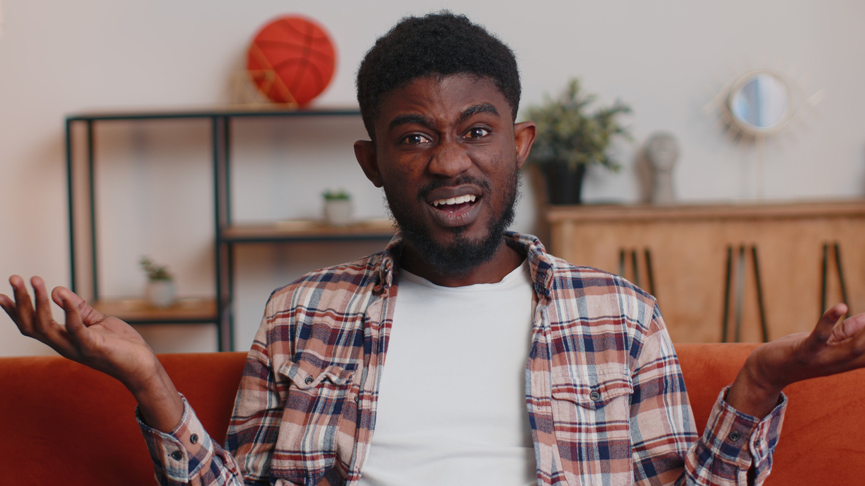 Confused man raising hands in indignant expression, asking why, what reason of failure at home